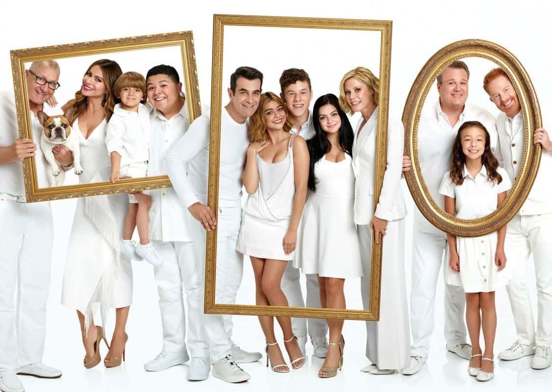 Poster med familjerna i Modern Family, alla klädda i vitt med ramar som visar vilken familj som de tillhör.